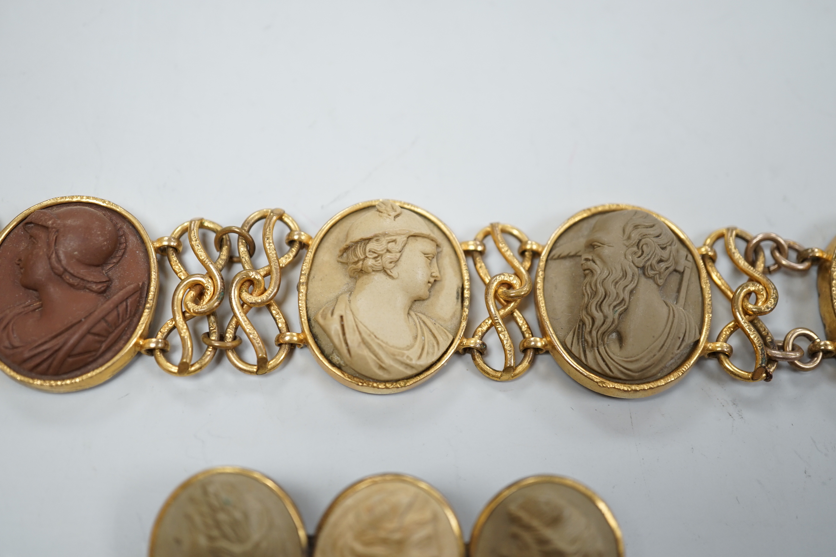 A 19th century gilt metal and oval lava panel set bracelet, 16.8cm and a similar brooch.